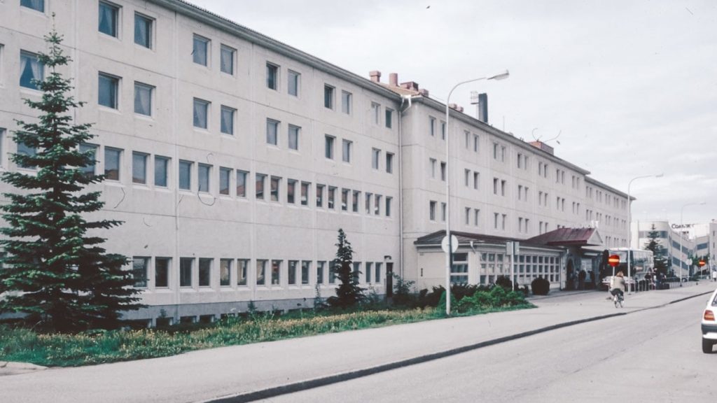 A large white building sitting on the side of a road