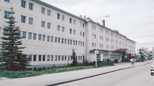 A large white building sitting on the side of a road