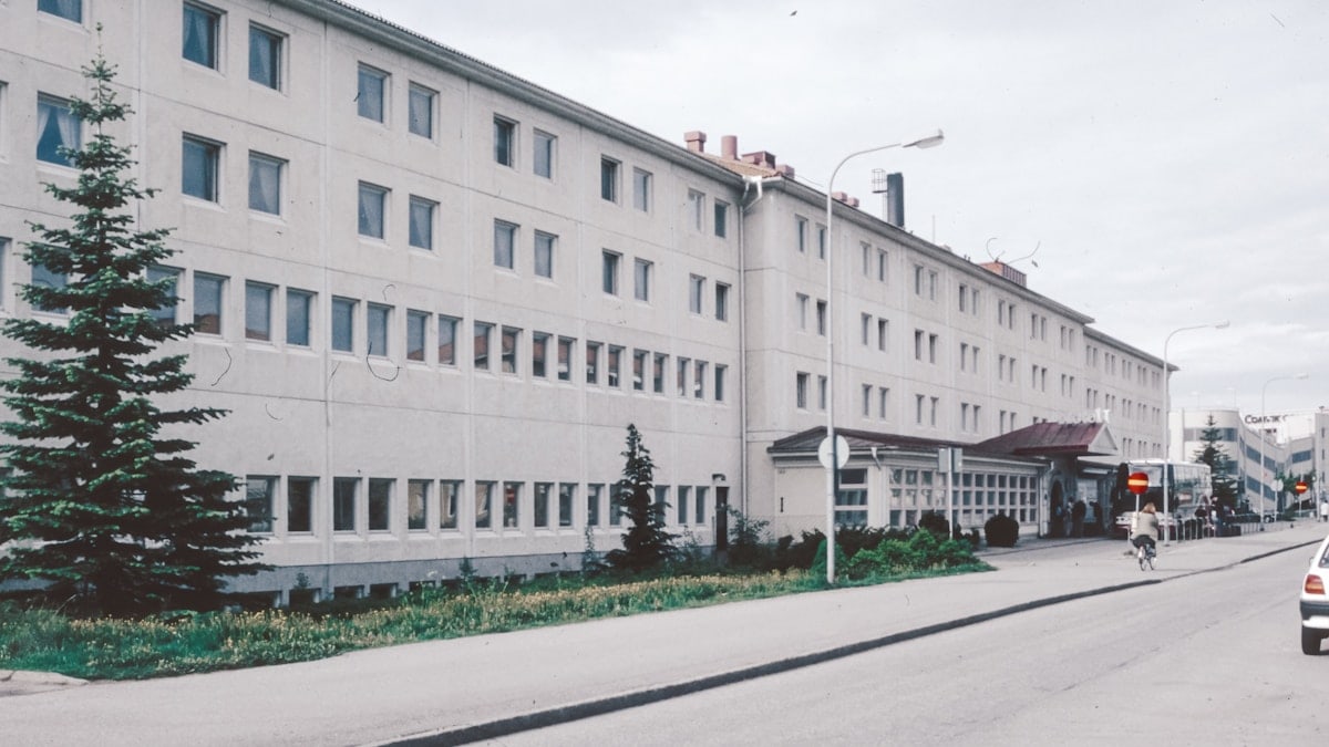 A large white building sitting on the side of a road